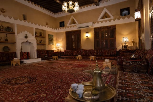 Traditional Saudi Arabian majlis with cushions along the walls