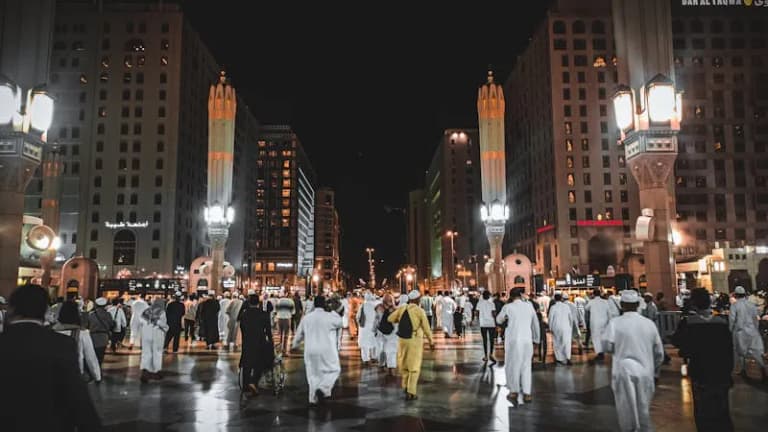 Busy street in Medina at night with lights and people